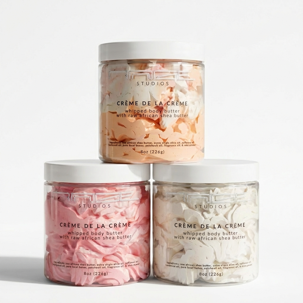 Three jars of 'Creme de la Creme' whipped body butter on a light gray background