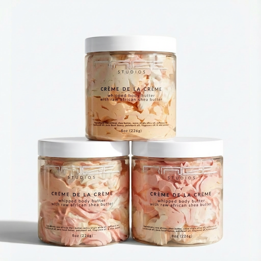 Three jars of 'Creme de la Creme' whipped body butter on a light gray background